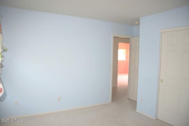 spare room featuring light colored carpet