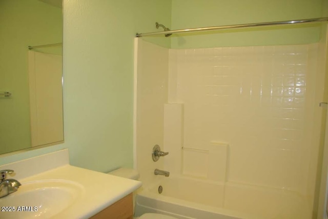 full bathroom with toilet, vanity, and washtub / shower combination