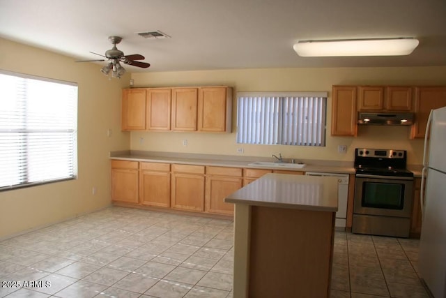 kitchen with a sink, under cabinet range hood, white appliances, light countertops, and ceiling fan