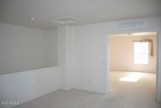 unfurnished room featuring visible vents and carpet floors