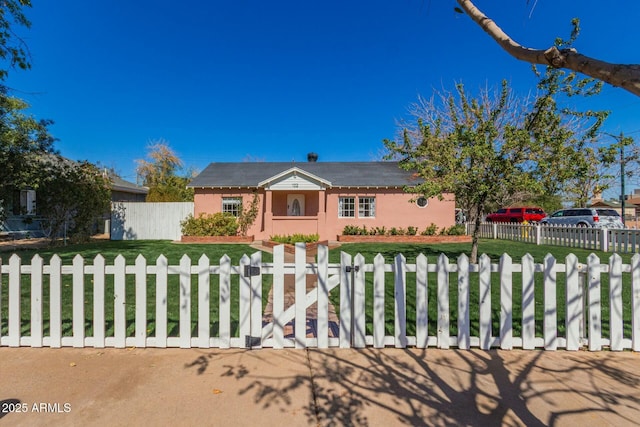 single story home featuring a fenced front yard, a front lawn, and stucco siding