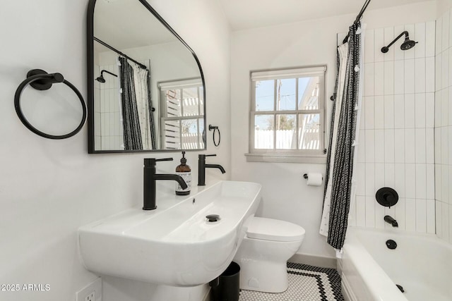 bathroom with tile patterned flooring, toilet, a sink, baseboards, and shower / bathtub combination with curtain