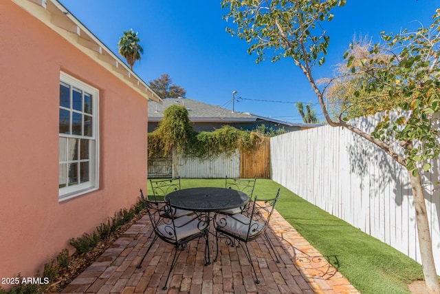 view of patio / terrace featuring outdoor dining space and a fenced backyard