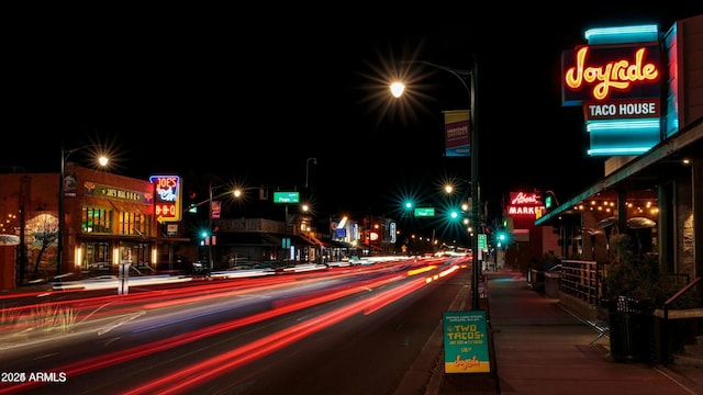 exterior space featuring sidewalks, traffic lights, curbs, and street lights