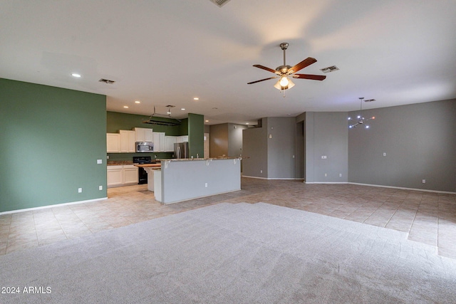 unfurnished living room featuring baseboards, visible vents, light tile patterned floors, and ceiling fan