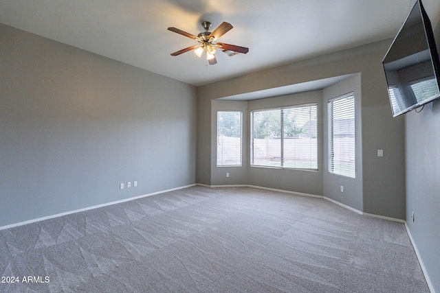 unfurnished room with baseboards, ceiling fan, and carpet flooring