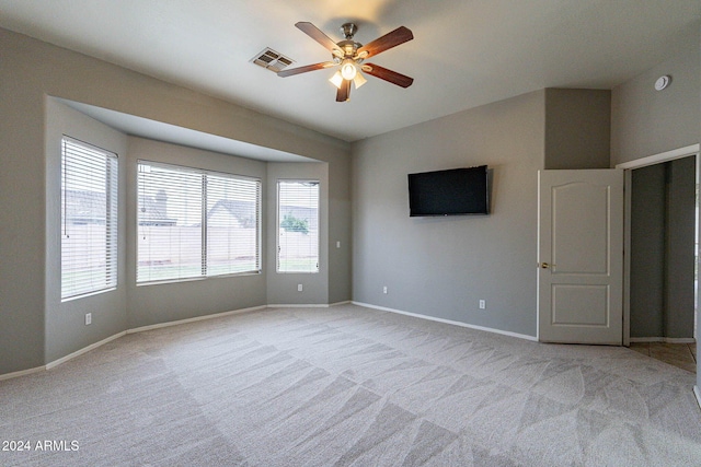 carpeted empty room featuring ceiling fan