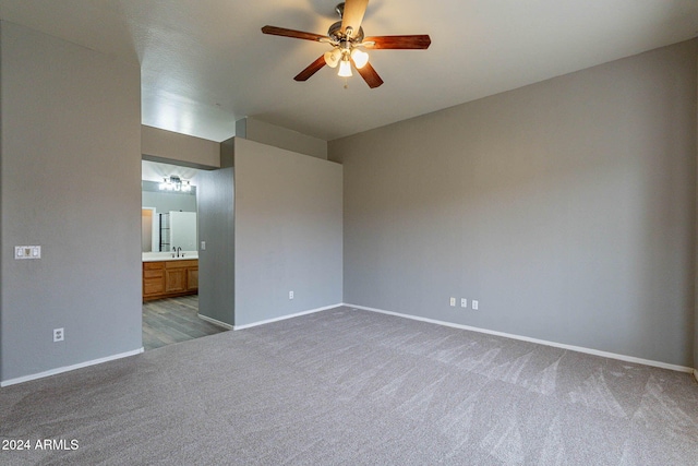 carpeted empty room featuring sink and ceiling fan