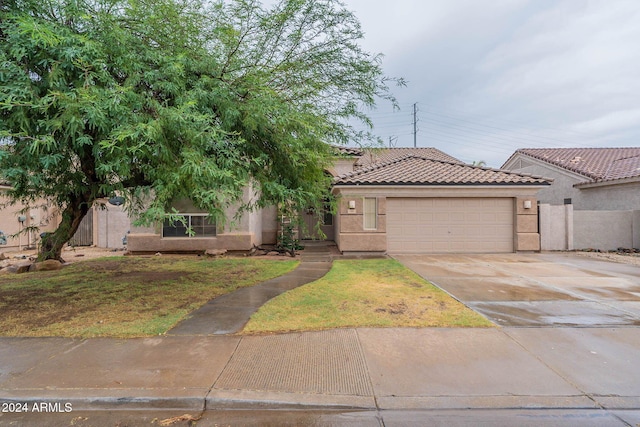 view of front of home featuring a front yard and a garage