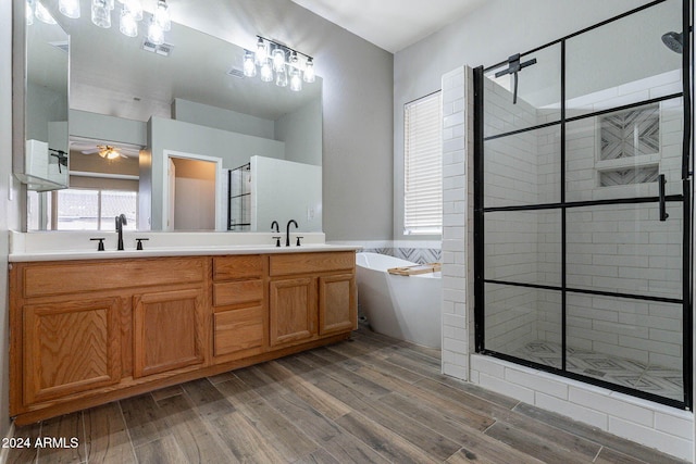 bathroom with vanity, ceiling fan, separate shower and tub, and hardwood / wood-style floors