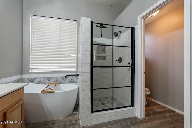 full bathroom with vanity, toilet, hardwood / wood-style flooring, and plus walk in shower