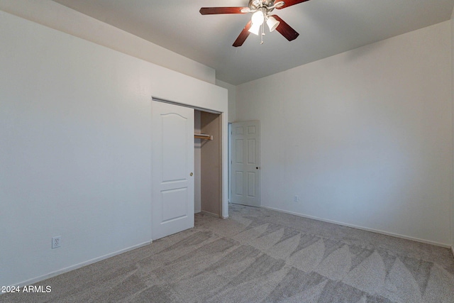 unfurnished bedroom with a closet, ceiling fan, and light carpet