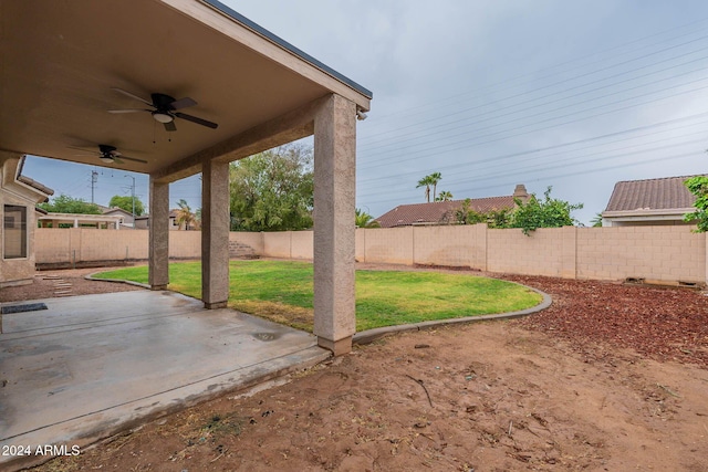 view of yard featuring a fenced backyard, a ceiling fan, and a patio area