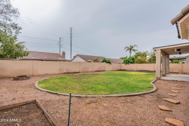 view of yard featuring a patio, a ceiling fan, and a fenced backyard