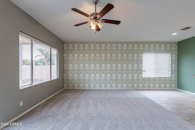 unfurnished room featuring ceiling fan and light tile patterned floors