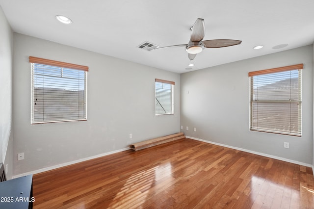 empty room with wood-type flooring and ceiling fan