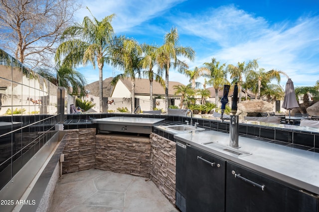 view of patio with sink and exterior kitchen