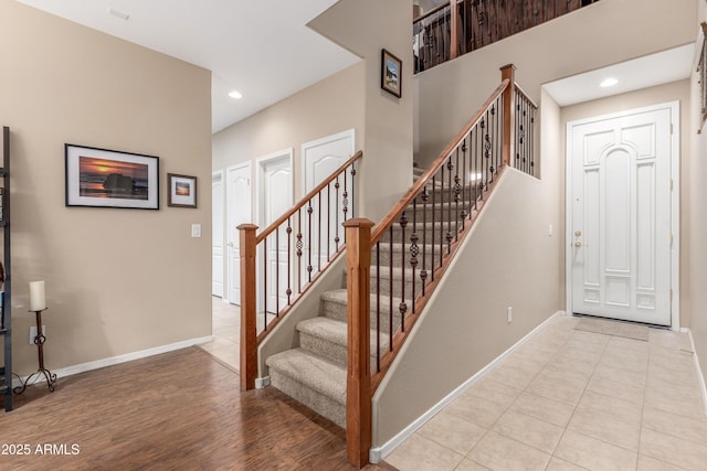 interior space featuring stairs, recessed lighting, wood finished floors, and baseboards