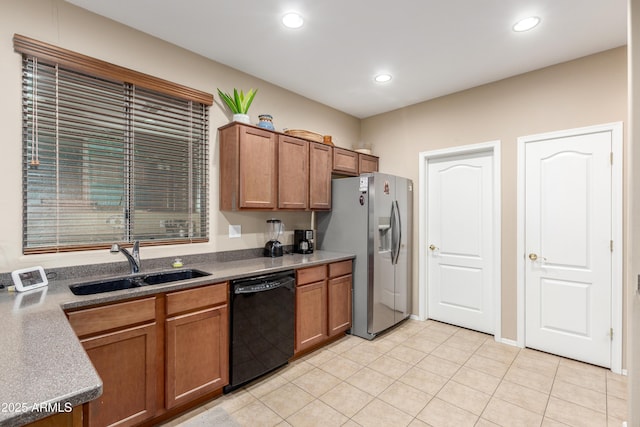 kitchen with recessed lighting, brown cabinetry, a sink, stainless steel fridge, and dishwasher