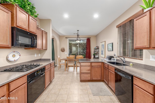 kitchen with light tile patterned floors, arched walkways, a peninsula, black appliances, and a sink