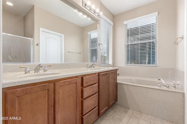 full bathroom with a bath, a stall shower, tile patterned flooring, and a sink