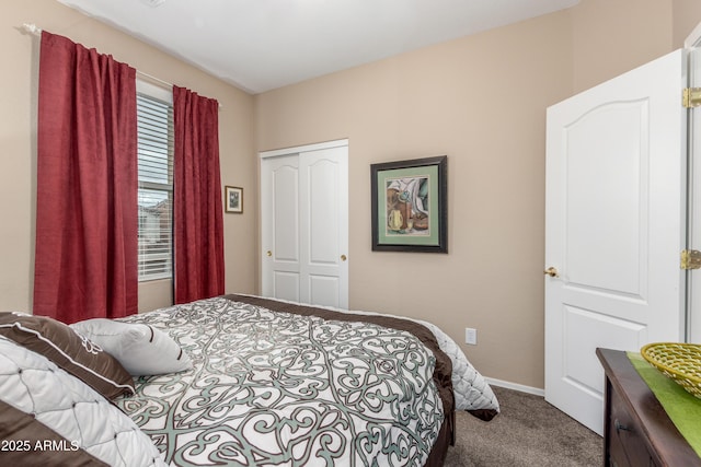 bedroom with a closet, carpet, and baseboards