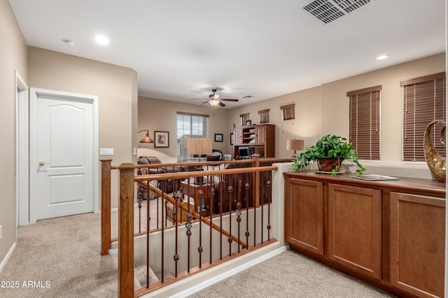 interior space with visible vents, brown cabinetry, light colored carpet, ceiling fan, and recessed lighting