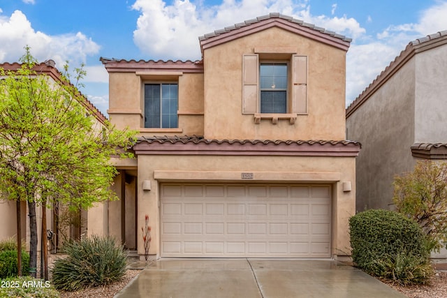 mediterranean / spanish-style home with concrete driveway, an attached garage, and stucco siding