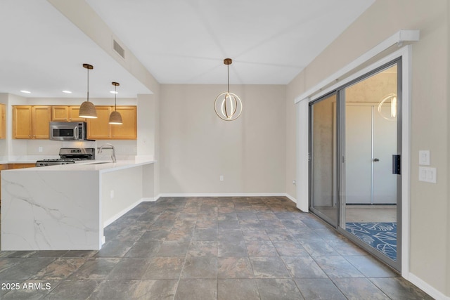 20121 N 76th St Unit 2021, Scottsdale, AZ 85255 - kitchen featuring stainless steel appliances, baseboards, dark stone finish floors, a sink, and recessed lighting