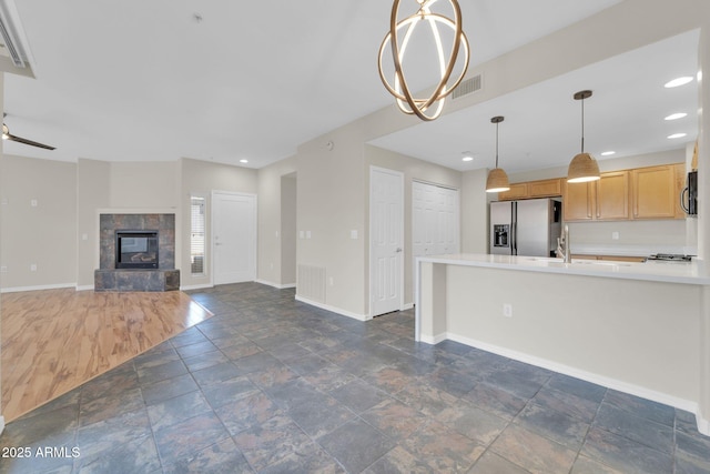 20121 N 76th St Unit 2021, Scottsdale, AZ 85255 - unfurnished living room with baseboards, dark stone finish floors, recessed lighting, a sink, and a premium fireplace