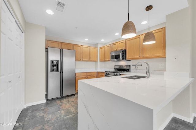 20121 N 76th St Unit 2021, Scottsdale, AZ 85255 - kitchen featuring appliances with stainless steel finishes, a sink, baseboards, a peninsula, and light stone countertops