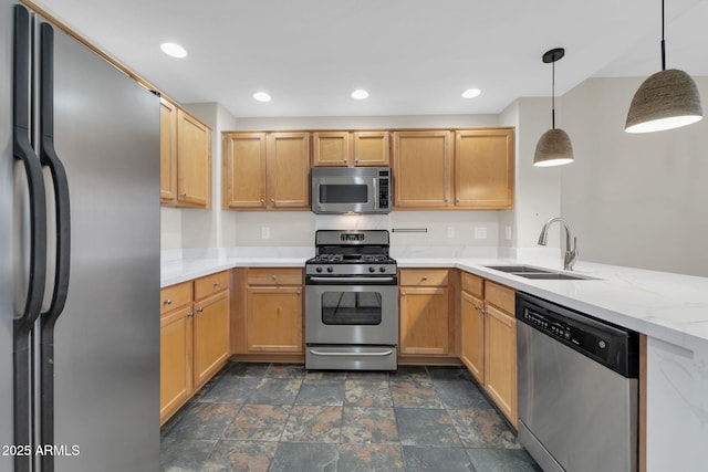 20121 N 76th St Unit 2021, Scottsdale, AZ 85255 - kitchen with stainless steel appliances, a sink, dark stone finish floors, hanging light fixtures, and light stone counters