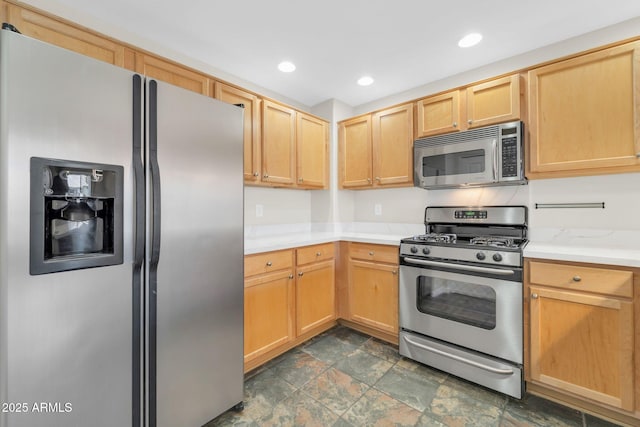 20121 N 76th St Unit 2021, Scottsdale, AZ 85255 - kitchen featuring appliances with stainless steel finishes, stone finish flooring, light countertops, light brown cabinets, and recessed lighting