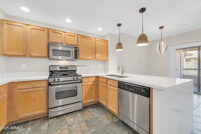 20121 N 76th St Unit 2021, Scottsdale, AZ 85255 - kitchen with stainless steel appliances, a sink, a peninsula, recessed lighting, and hanging light fixtures