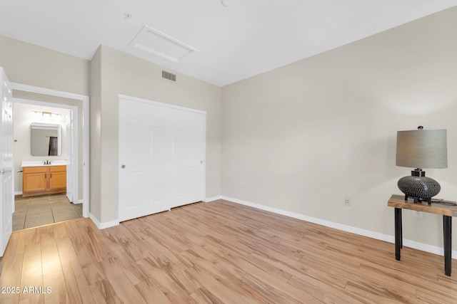20121 N 76th St Unit 2021, Scottsdale, AZ 85255 - unfurnished bedroom featuring attic access, light wood-style floors, and baseboards