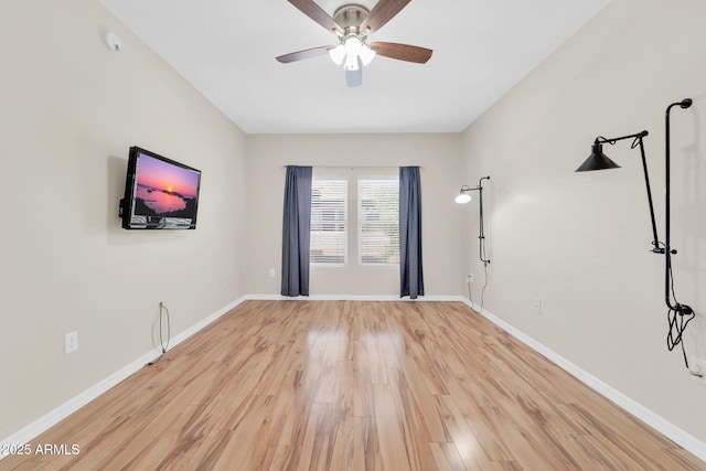 20121 N 76th St Unit 2021, Scottsdale, AZ 85255 - empty room featuring wood finished floors, ceiling fan, and baseboards
