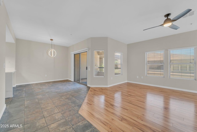 20121 N 76th St Unit 2021, Scottsdale, AZ 85255 - unfurnished living room with baseboards, ceiling fan, and stone finish flooring