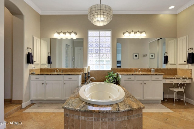 bathroom featuring a whirlpool tub, crown molding, and a sink