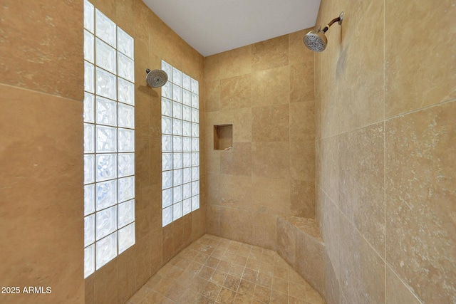 bathroom with a tile shower