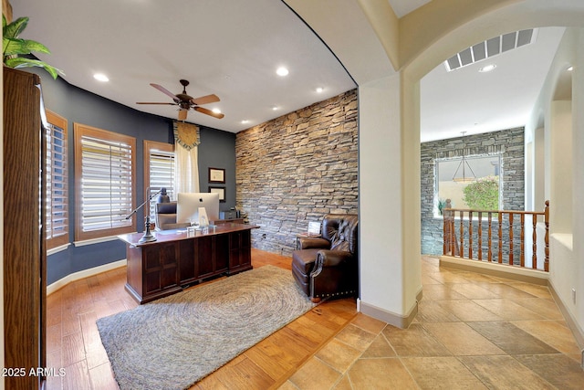 office featuring arched walkways, visible vents, and baseboards