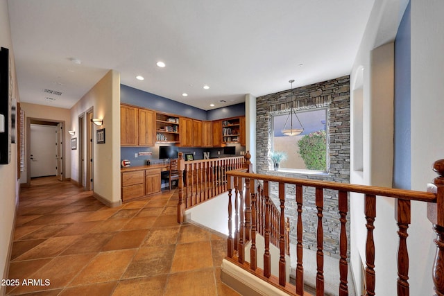 hall with baseboards, visible vents, stone finish floor, an upstairs landing, and recessed lighting