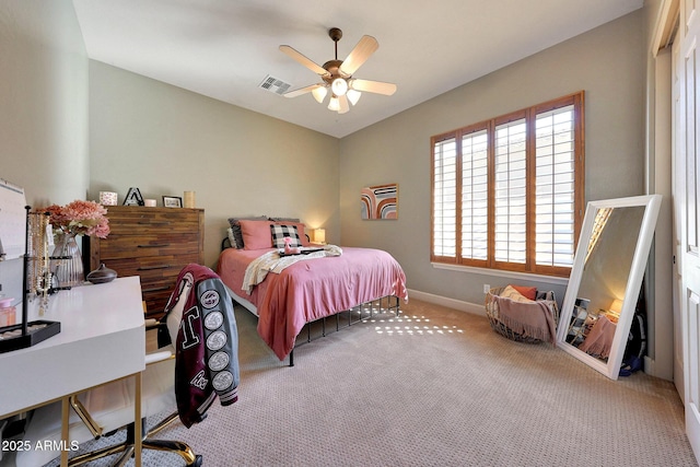 carpeted bedroom with lofted ceiling, a ceiling fan, visible vents, and baseboards