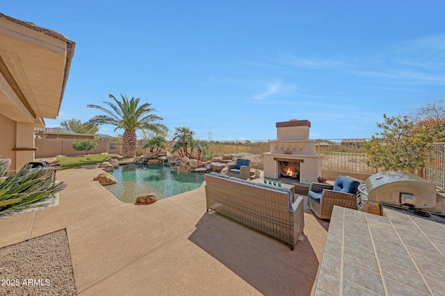 view of swimming pool featuring a fenced in pool, a patio, grilling area, an outdoor living space with a fireplace, and a fenced backyard