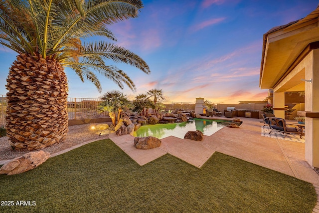 view of swimming pool featuring a fenced backyard, a fenced in pool, and a patio