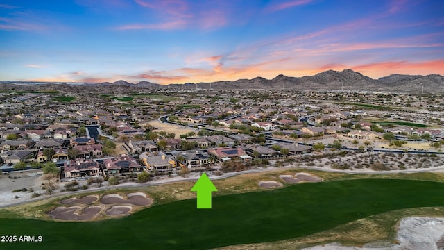 aerial view at dusk featuring a residential view and a mountain view