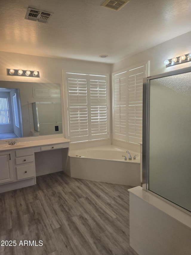 955 W Laurel Ave, Gilbert, AZ 85233 - full bath featuring vanity, wood finished floors, a garden tub, and a shower with shower door