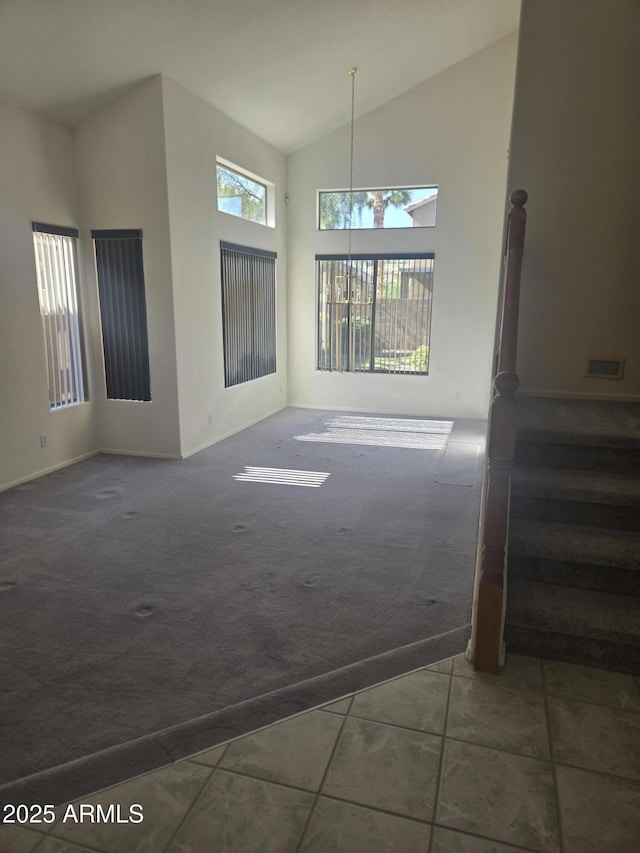 955 W Laurel Ave, Gilbert, AZ 85233 - unfurnished living room featuring high vaulted ceiling, tile patterned flooring, carpet, and stairway