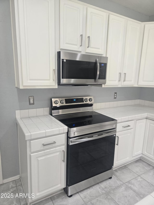 955 W Laurel Ave, Gilbert, AZ 85233 - kitchen featuring appliances with stainless steel finishes, tile counters, and white cabinetry