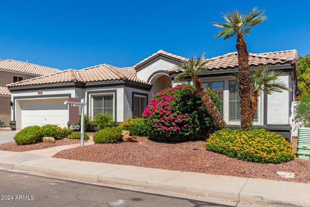 mediterranean / spanish-style home with a garage