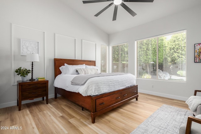 bedroom featuring light hardwood / wood-style floors, vaulted ceiling, and ceiling fan